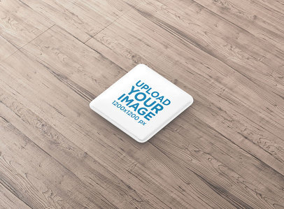 Mockup Featuring a Square Pin Button Placed on a Wooden Surface 