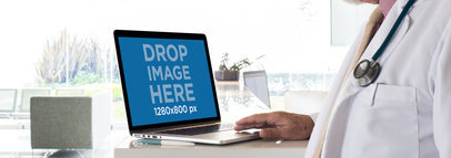 Doctor Working on his MacBook Pro Mockup a12442wide