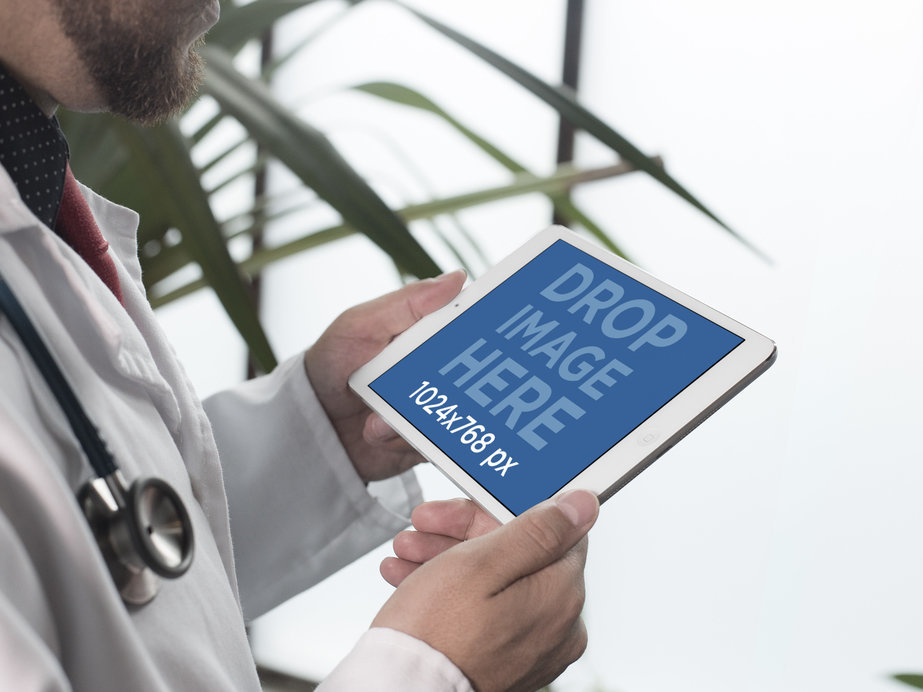 iPad Mockup in Landscape Mode of a Male Doctor Next to a Plant