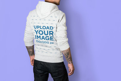 Mockup of the Back of a Man Wearing a Heather Hoodie at a Studio