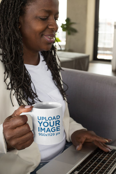 11 oz Mug Mockup Featuring a Middle-Aged Woman Drinking Coffee While Working 