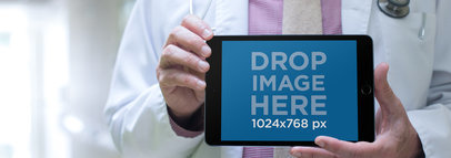 iPad Mini in Landscape View Held by a Senior Doctor a12447wide