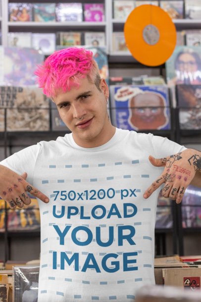 Mockup of a Man at a Record Store Pointing at His T-Shirt 