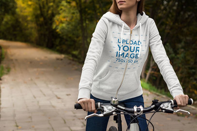 Heather Hoodie Mockup of a Woman Riding a Bicycle 