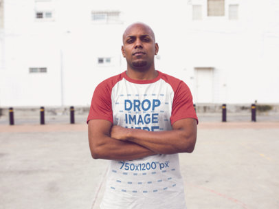 Raglan T-Shirt Mockup of a Man Crossing his Arms
