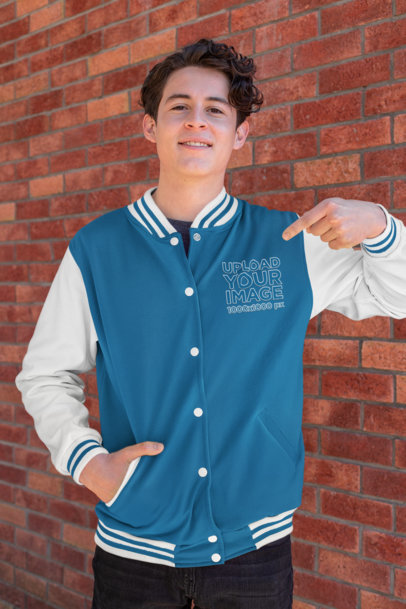 Mockup of a Young Man Pointing at His Varsity Jacket 33213