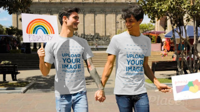 Video of a Couple with T-Shirts Holding Hands at the Pride Parade