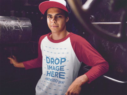 Raglan T-Shirt Mockup of a Guy Leaning Against a Train