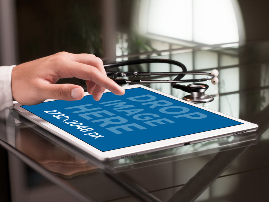 iPad Mockup in Landscape Position Over a Doctor’s Desk 