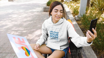 Hoodie Video of a Woman Recording Herself with Her Phone at Pride Parade
