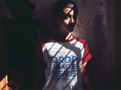 Pretty Woman Wearing a Raglan Tee Mockup Standing in the Shadow