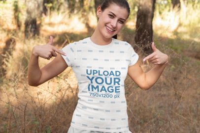 Mockup Featuring a Happy Young Woman Pointing at Her Sublimated T-Shirt 33082