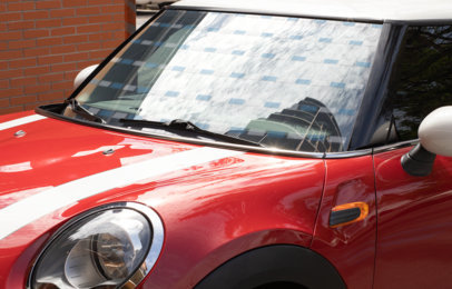 Mockup of a Decal on the Window of a Red Compact Car