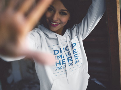 Trendy Woman Wearing a Hoodie Mockup Playing Around