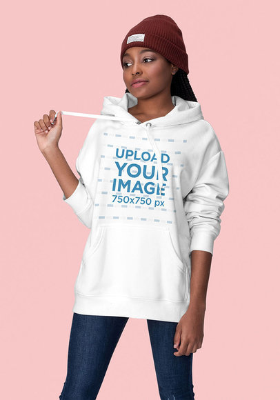 Mockup of a Sassy Young Woman Wearing a Hoodie at a Studio