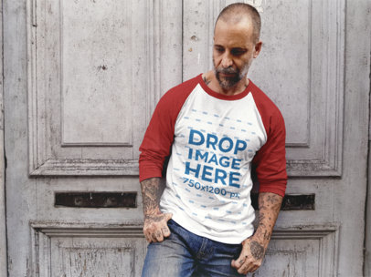 Raglan T-Shirt Mockup of a Middle-Aged Guy Leaning Against a Wooden Door