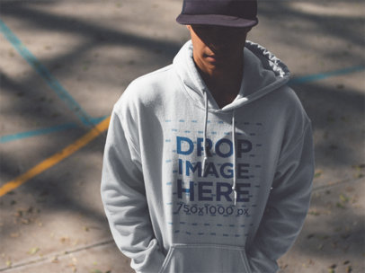 Hoodie Mockup of a Guy Wearing a Hat and Hiding in the Shadow