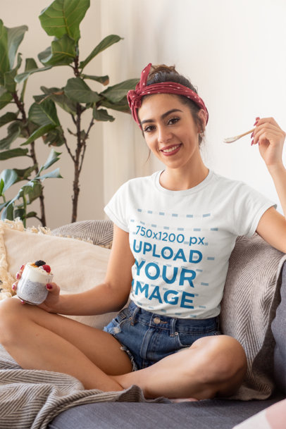 Mockup of a Woman Wearing a T-Shirt While Eating a Healthy Breakfast 