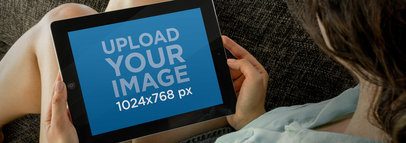 Mockup of a Woman Holding an iPad Against Her Legs  -