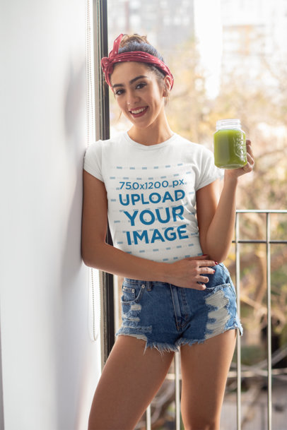 T-Shirt Mockup Featuring a Woman Holding a Healthy Juice