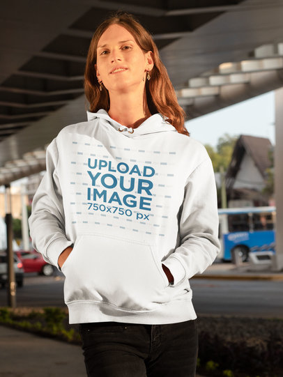 Mockup of a Woman Wearing a Hoodie in an Urban Setting
