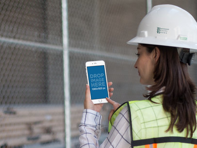 iPhone Mockup in Portrait Position of a Female Operator with Blurry Background