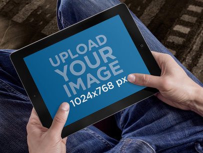 Mockup of a Man using an iPad on a Couch