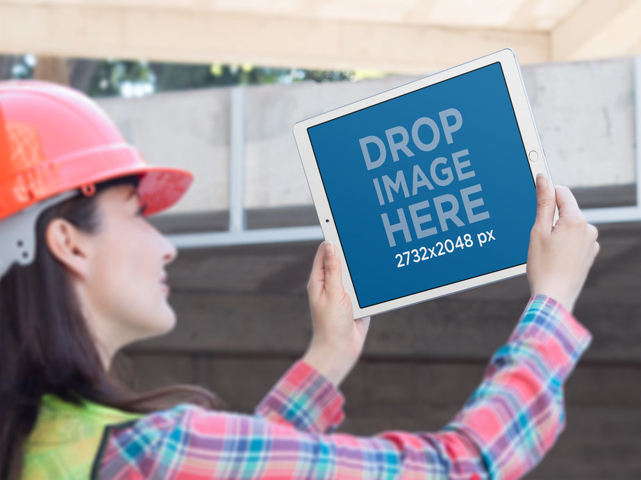 Mockup Featuring a Female Engineer Holding an iPad in Landscape Position in the Air 