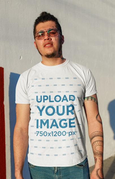 T-Shirt Mockup Featuring a Tattooed Man at Sunset
