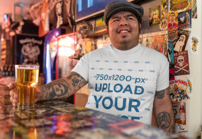 Mockup of a Tattooed Man with a T-Shirt Smiling at a Bar 