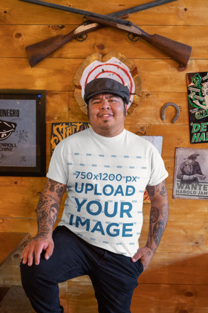 T-Shirt Mockup Featuring a Happy Man With Tattoos Posing at a Bar 