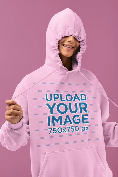 Hoodie Mockup Featuring a Woman Doing a Silly Pose in a Studio