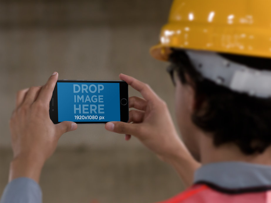 Mockup of a Man with a Protection Helmet Checking His iPhone 6 Plus