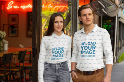 Sublimated Long Sleeve Polo Shirt Mockup of a Couple at a Street 33472