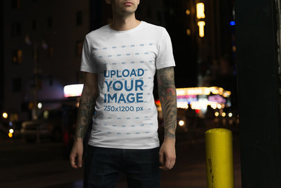 T-Shirt Mockup of a Tattooed Man in the Street at Night
