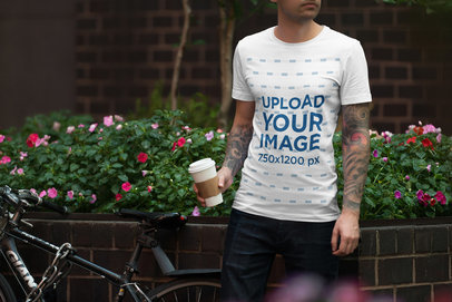 T-Shirt Mockup Featuring a Tattooed Man Holding a Man Posing by a Planter With Flowers 1956-el1