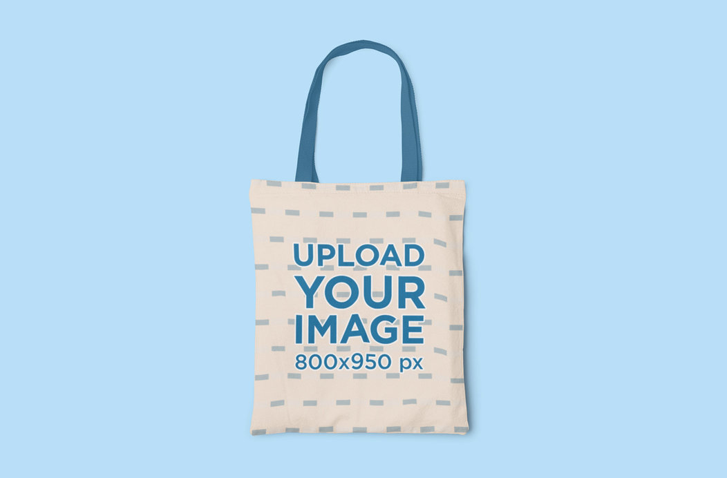 Mockup of a Sublimated Tote Bag with Customizable Strap on a Colored Surface