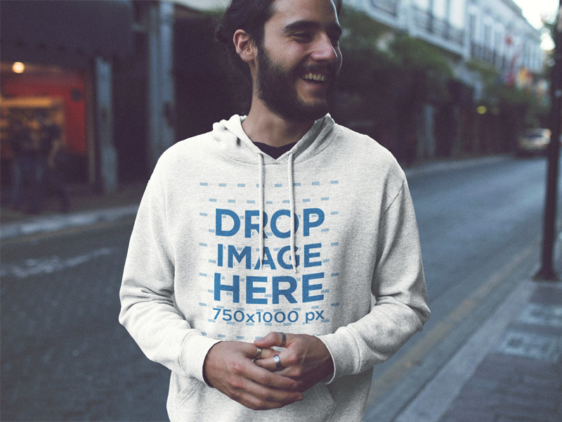 Pullover Hoodie Mockup of a Handosme Young Man with Long Hair Laughing in the City