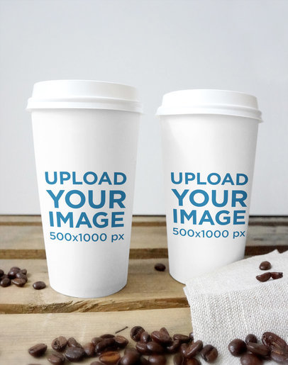 Mockup of Two Paper Cups Placed on a Wooden Surface by Some Coffee Beans