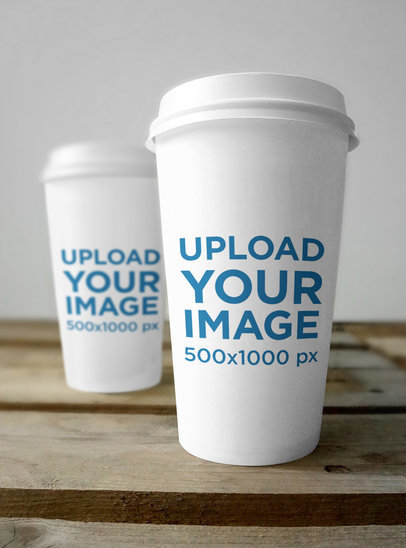 Mockup of Two Customizable Coffee Cups Placed on a Wooden Surface