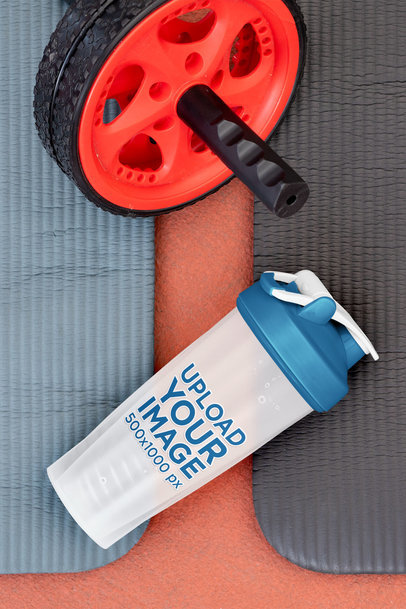 Mockup of a Blender Bottle Placed Next to an Ab Wheel 