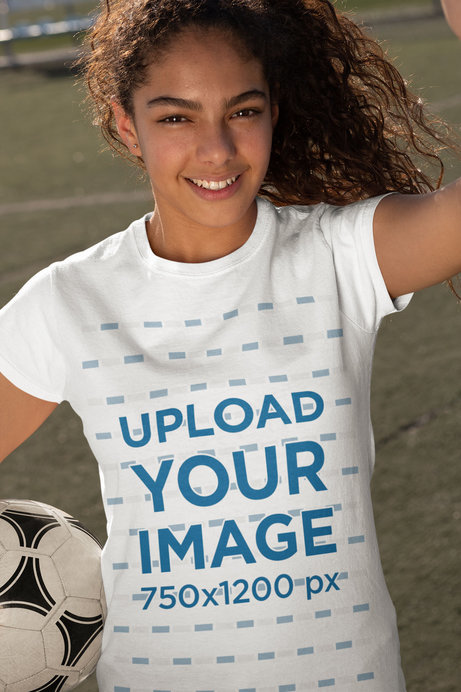 T-Shirt Mockup of a Teen Girl Taking a Selfie with a Soccer Ball 