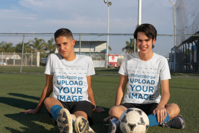 T-Shirt Mockup of Two Teenagers in a Soccer Field