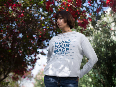 Young Trendy Woman with Short Hair Wearing a Pullover Hoodie Mockup Out in a Flower Grove