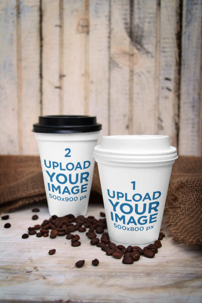 Mockup of Two Customizable Paper Cups Placed Surrounded by Coffee Beans 