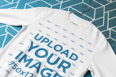 Mockup of a Sweatshirt Lying on a Patterned Quilt 33718