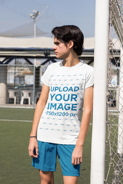 Jersey Mockup of a Soccer Player Leaning Against a Goal Post