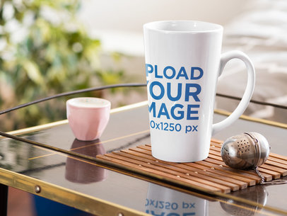 Mockup of a Conical 15 oz Coffee Mug Next to a Tea Infuser 