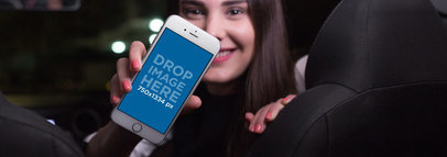 Woman in the Front Seat of a Car Holding a White iPhone 7 Mockup in Portrait Position Mockup a12802wide