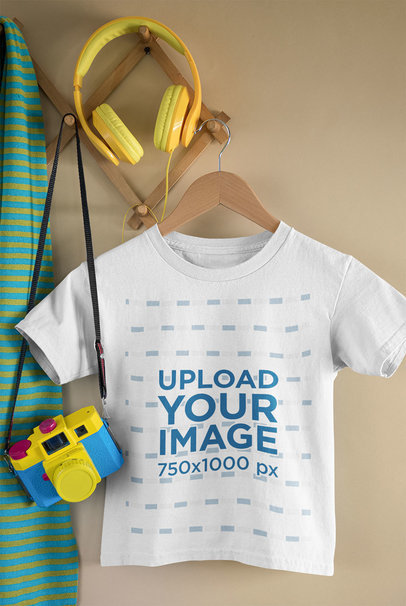 Mockup of a Kid's T-Shirt Featuring a Toy Camera and Headphones 33738